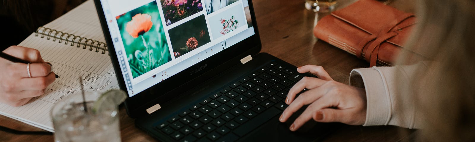 A group of people working on laptops while in a bar drinking