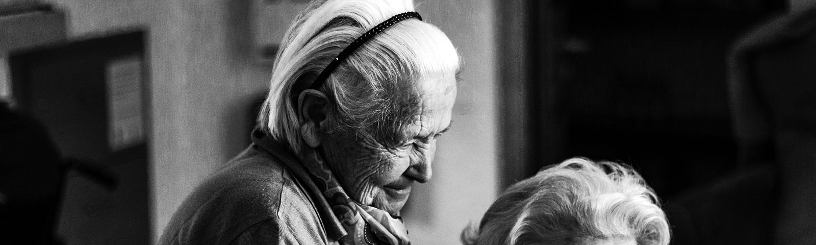 Black and white photo of two elderly women friends.