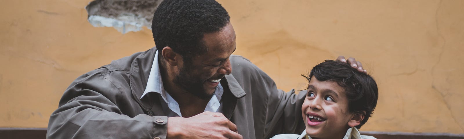 Dad and Son sitting together and smiling