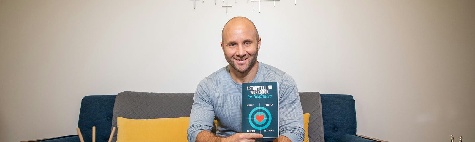 pic of a man holding a book entitled “ A Storytelling Workbook”