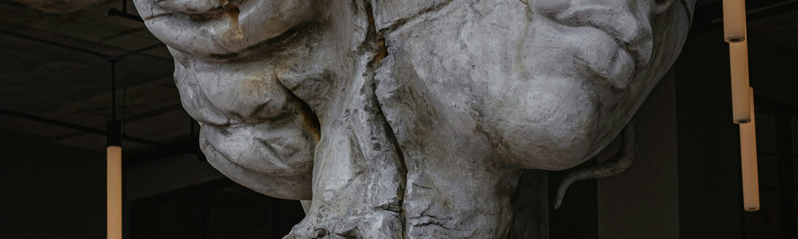 Cracked statue of a woman.