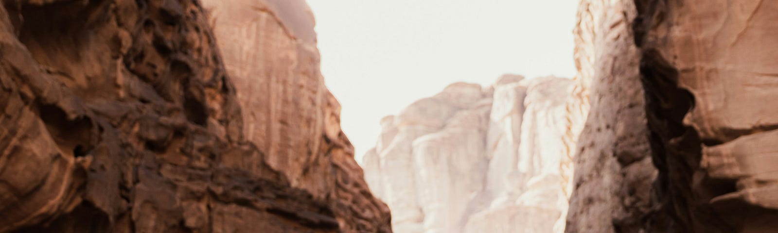 Man in a mountain pass making a decision on path to take.