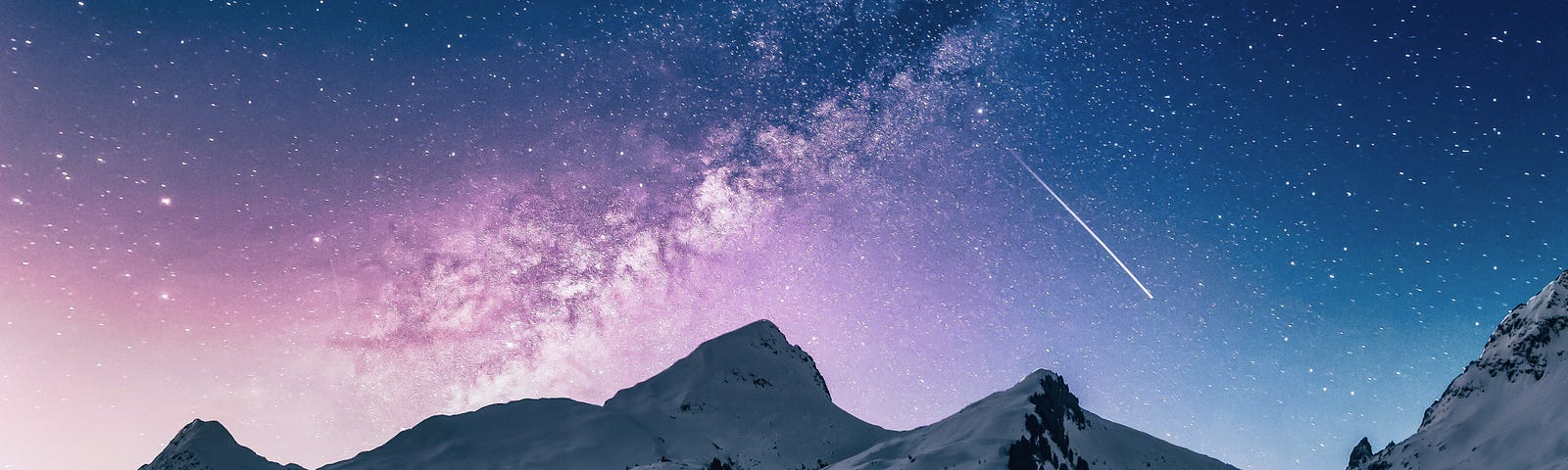 In a starry night, a shooting star heads toward snow-covered mountains