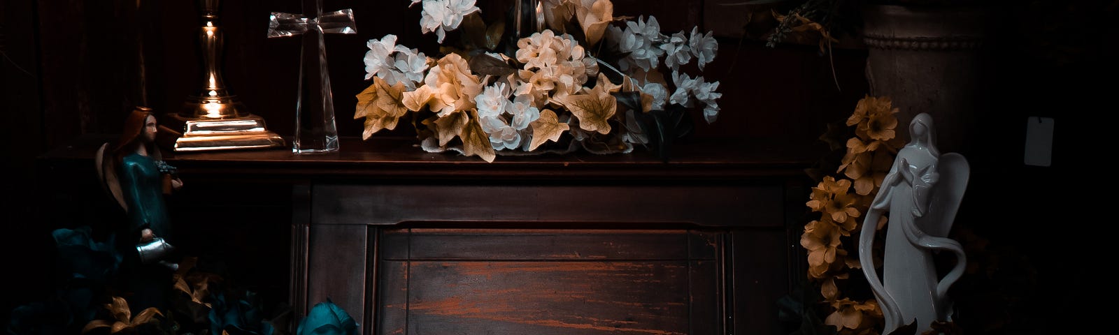 Romantic setting of flowers on piano and lamp.