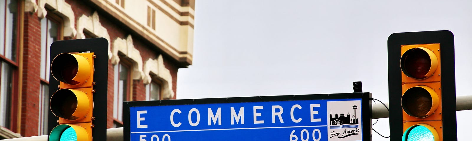 Blue city street sign stating “E COMMERCE”