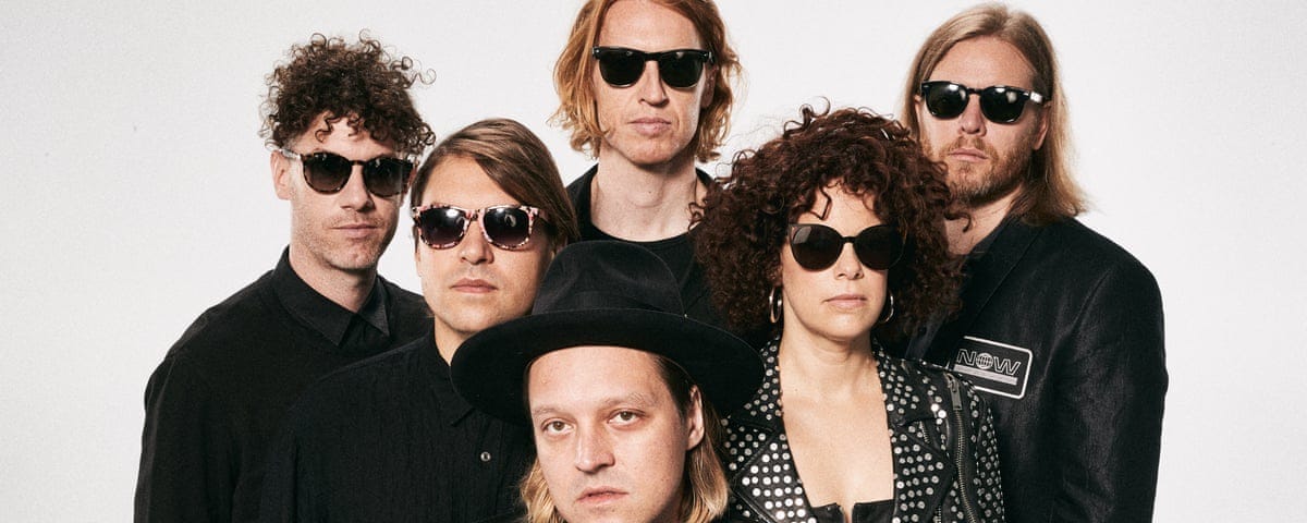 Arcade Fire band photo; all band members in black and everyone but frontman at bottom center in black sunglasses (instead wearing a black fedora) on a greyed-white background