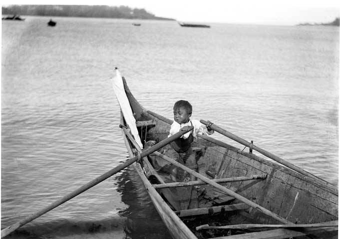 boy rowing a Makah canoe