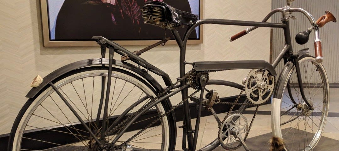 A strange looking bicycle with multiple sprockets and chains.