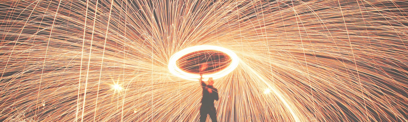 Man standing under fireworks.