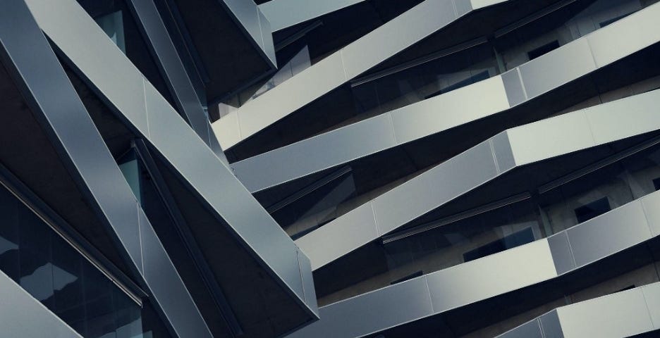 A modernist steel building with geometric balconies shot from below to create an abstract image from the angles.