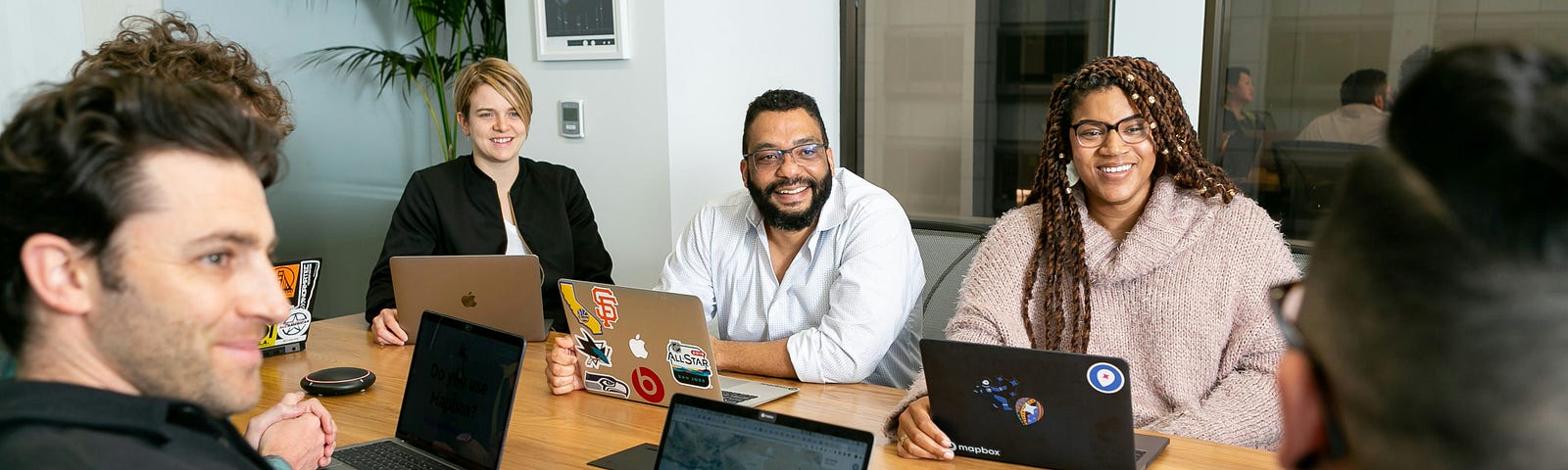 A gorup of office workers sitting around a table.