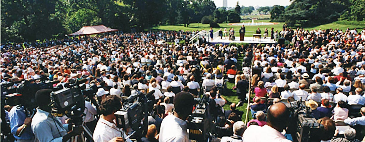 Thousands of people gather on the White House front lawn for the historic signing of the Americans with Disabilities Act.