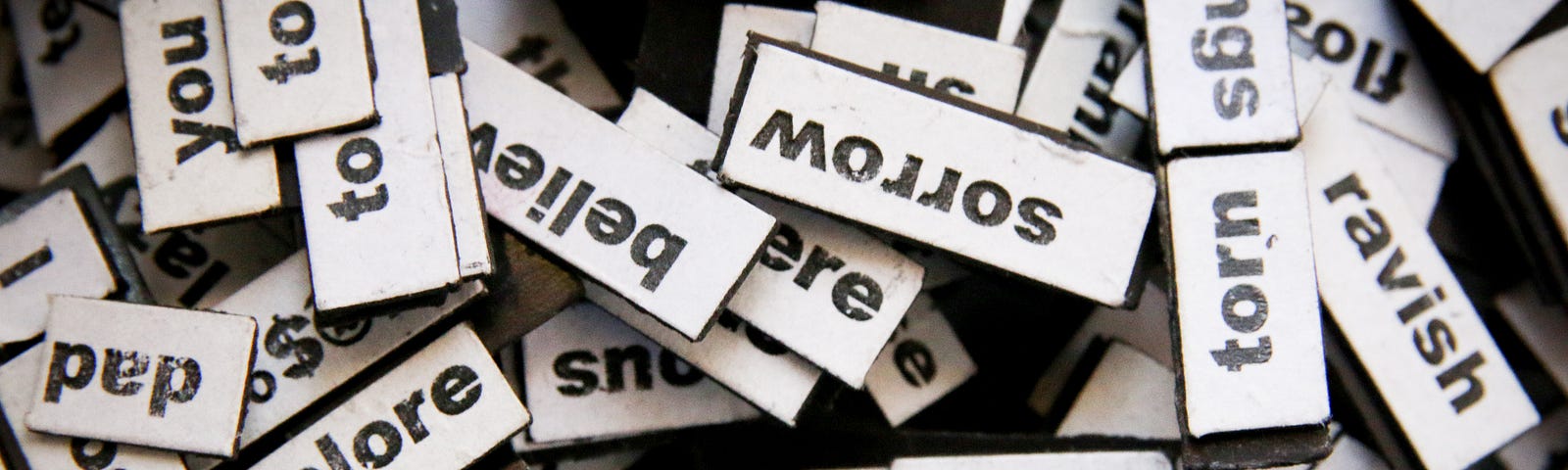 A muddled pile of blocks with words printed on them