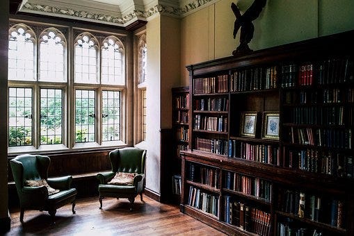 Library in Tudor building with a large bay window.