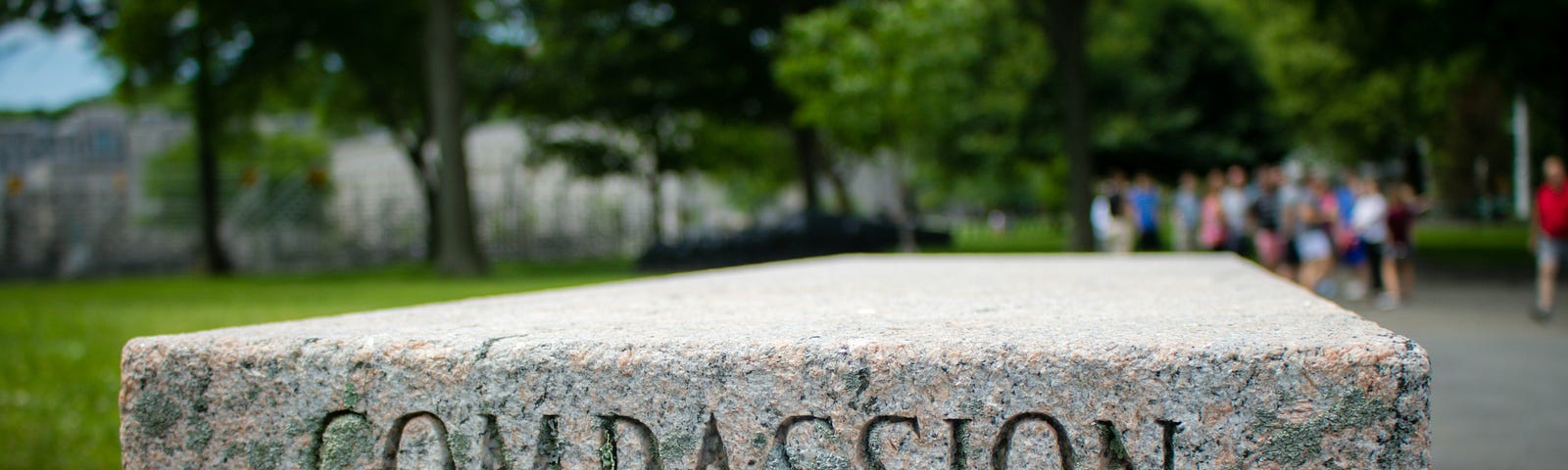 A stone bench with the word ‘compassion’ etched into the side.