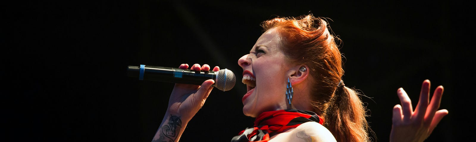 This is my fight song. Image of woman singing enthusiastically.