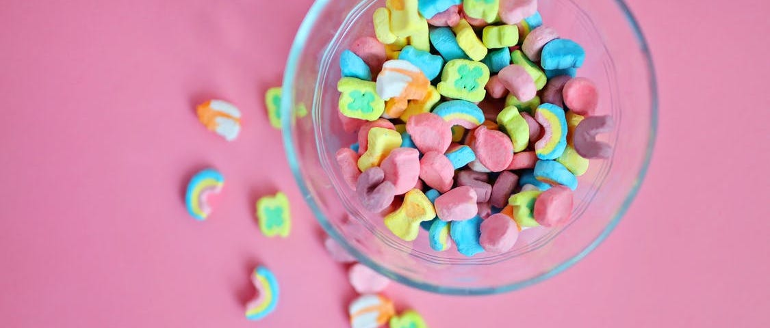 A bowl of Lucky Stars against a pink background