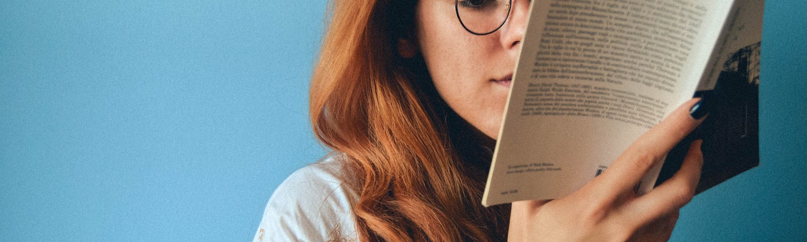 Woman in glasses reading.