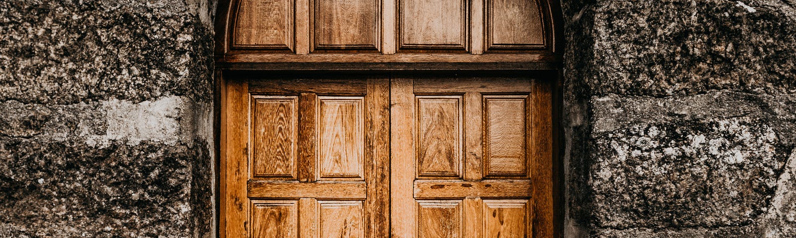 A wooden door in a castle wall.