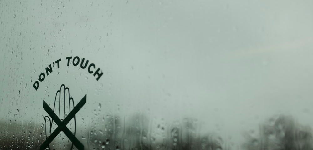 Picture of a rainy window with a crossed-out hand and text “Don’t touch”