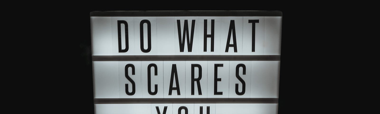 Lighted sign that says, Do what scares you