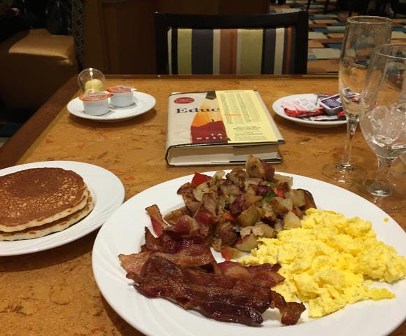 A bacon, egg, and potato breakfast with a side of pancakes and water. Taken at the Avenue Cafe at the MGM Grande in Las Vegas, Nevada.