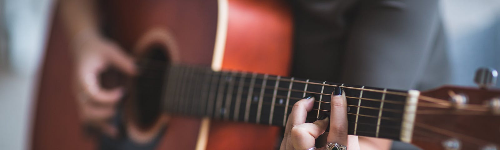 A woman playing the guitar