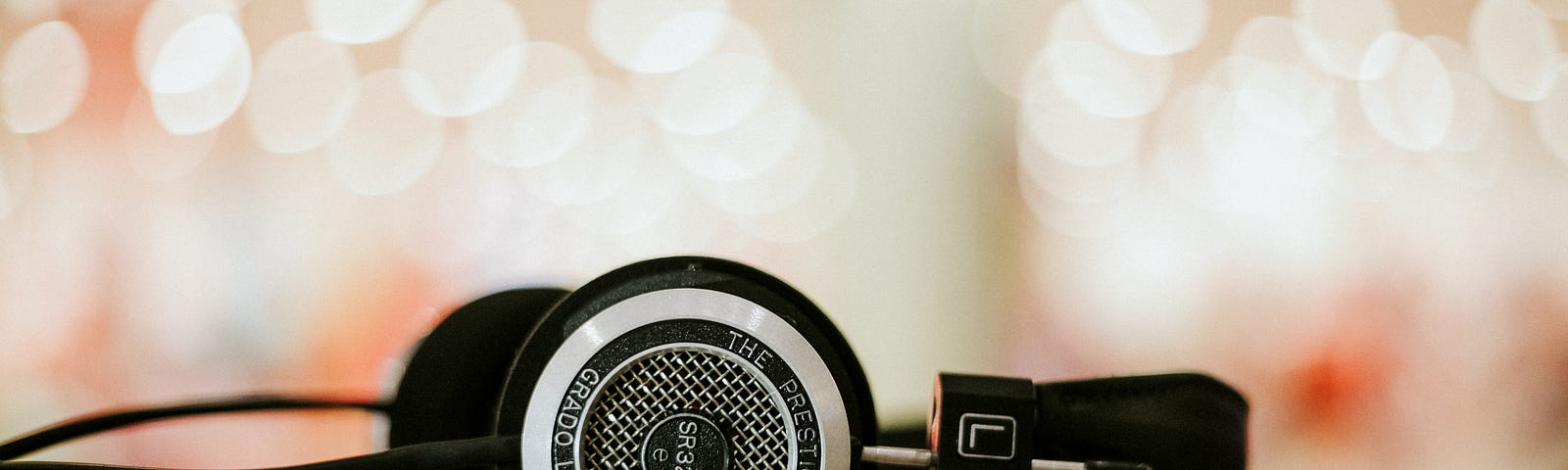 Black headphones on a sparkly backdrop