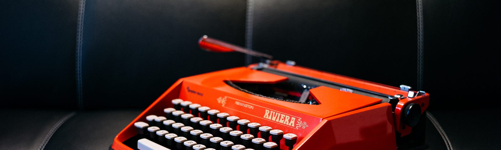 old red typewriter on a couch