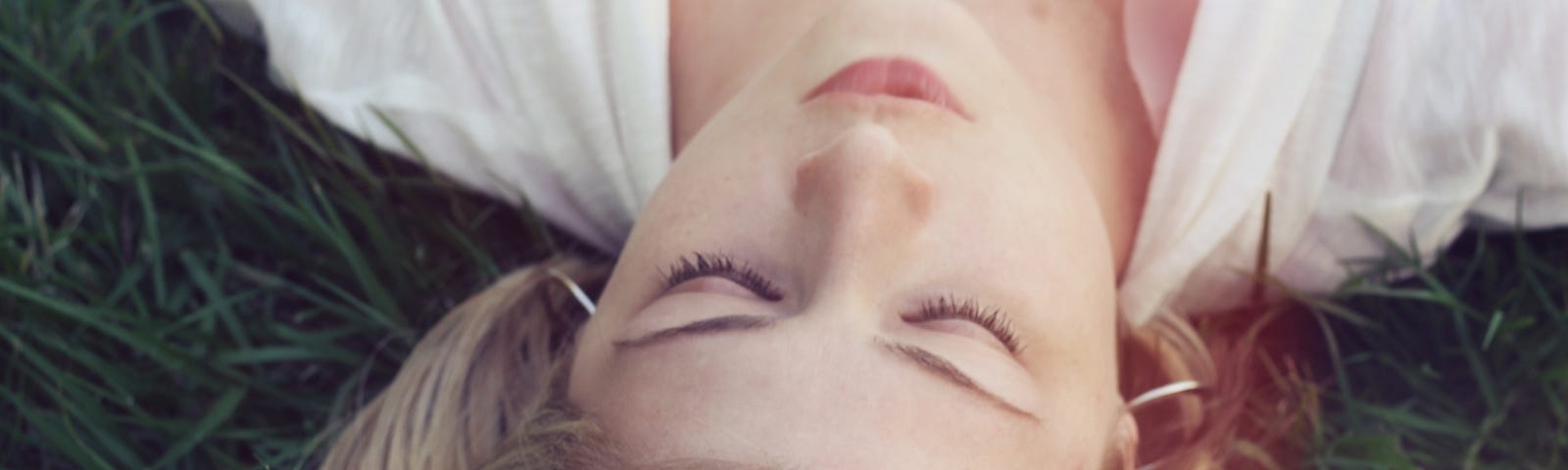 Woman laying down on the grass