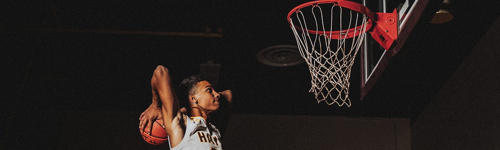 A man about to dunk a basketball