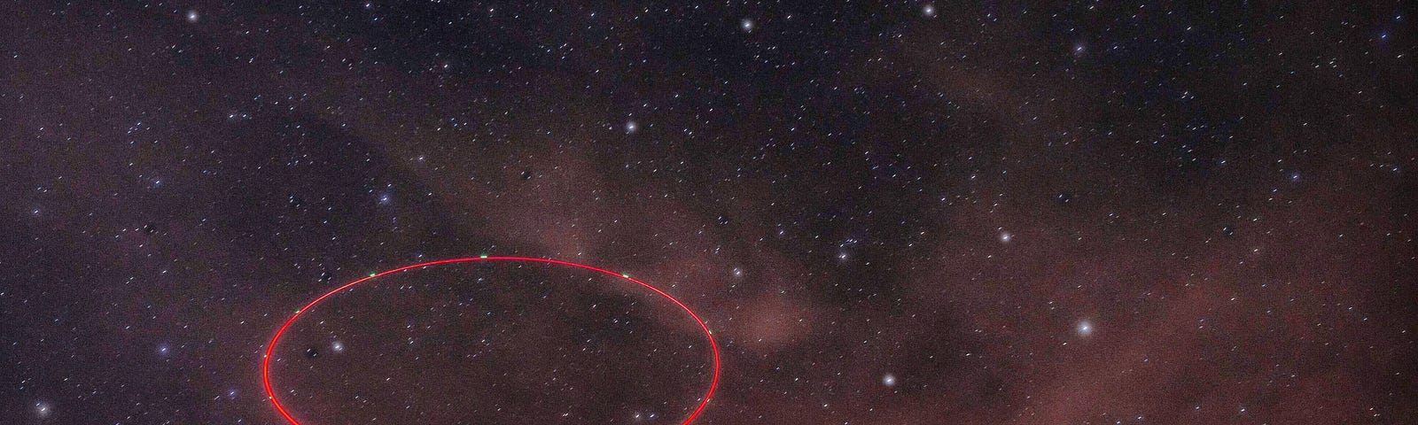 a stary, stary night time sky laced with low lying cluds over a moutnain. a red ciircle drawn to indicate the area where these planets can be seen.