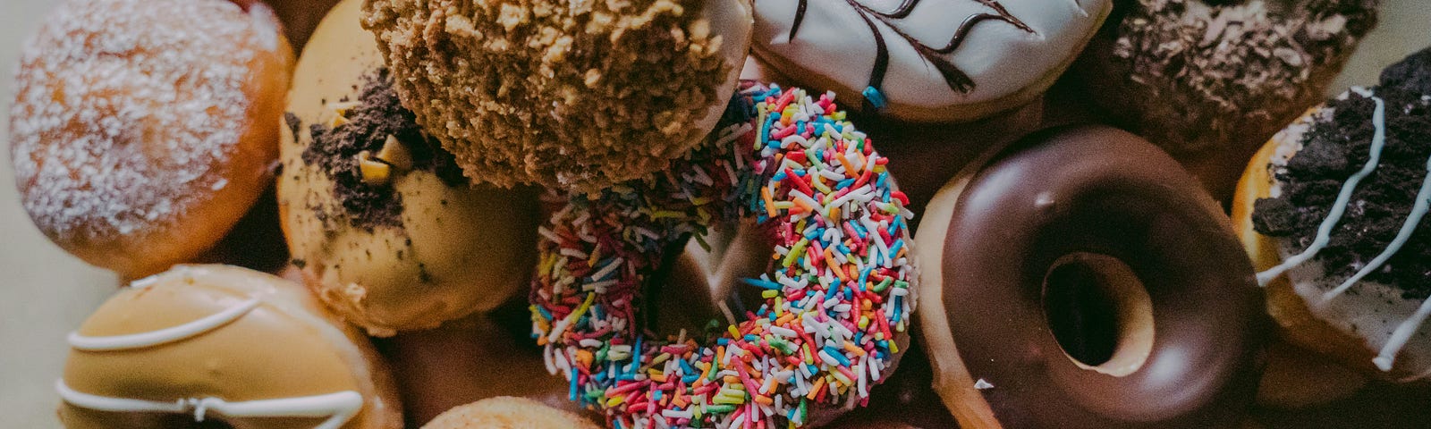 Close up of assortment of colorfully designed donuts