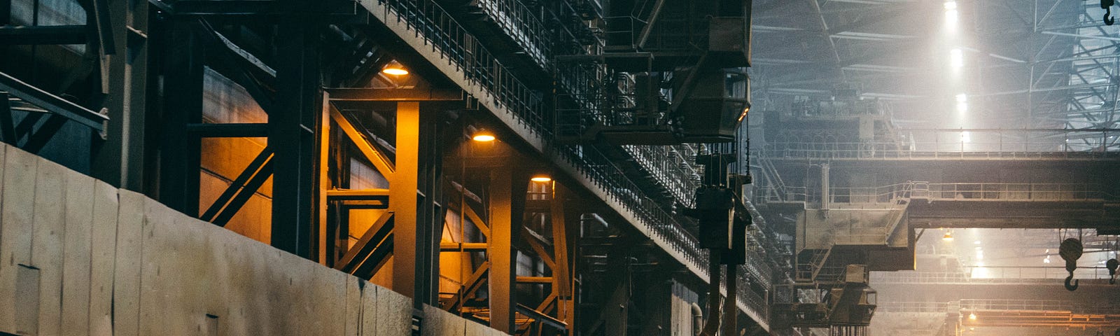 Hoists dangle overhead in a manufacturing plant