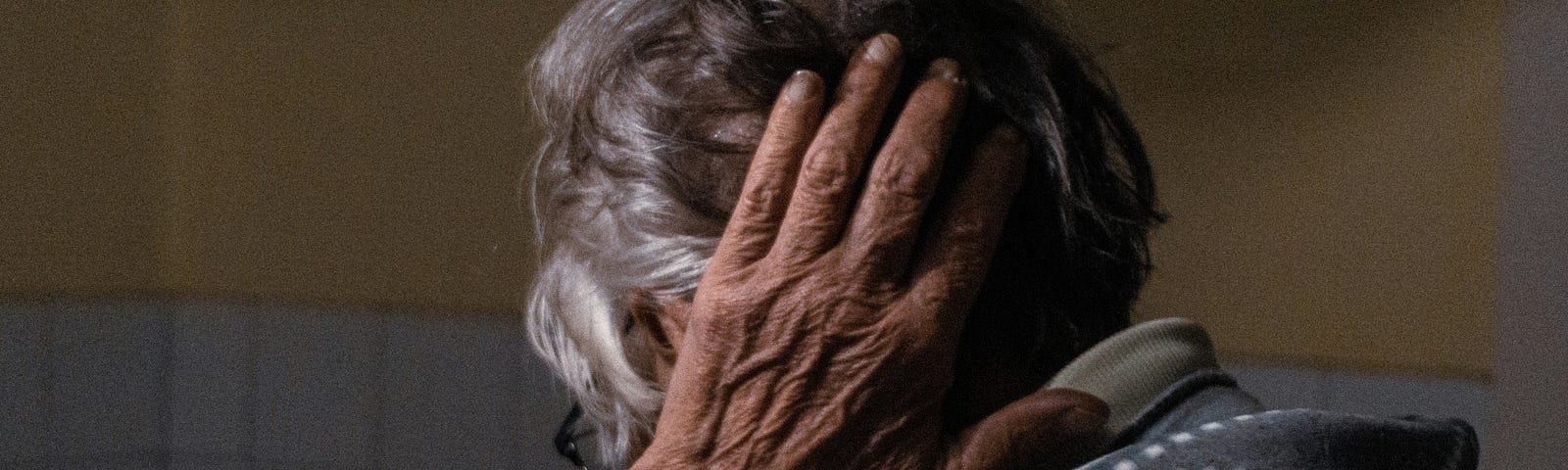 This is a photo of an older woman holding her hand behind her head as I often do these days.