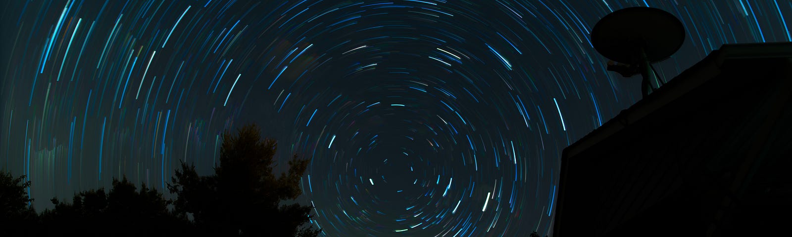 A whirlpool of lit stars or asteroids in the night sky against the shadow of the trees and landscape as if Twilight Zone of events to occur as in this story.