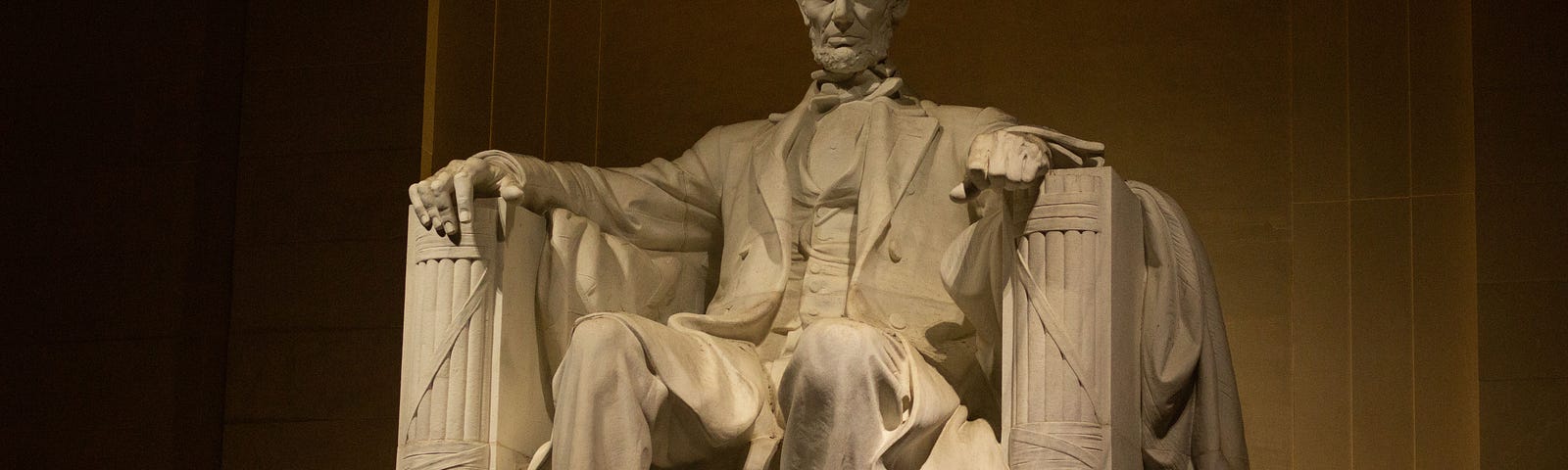 The statue of Lincoln sitting in a chair inside the Lincoln memorial