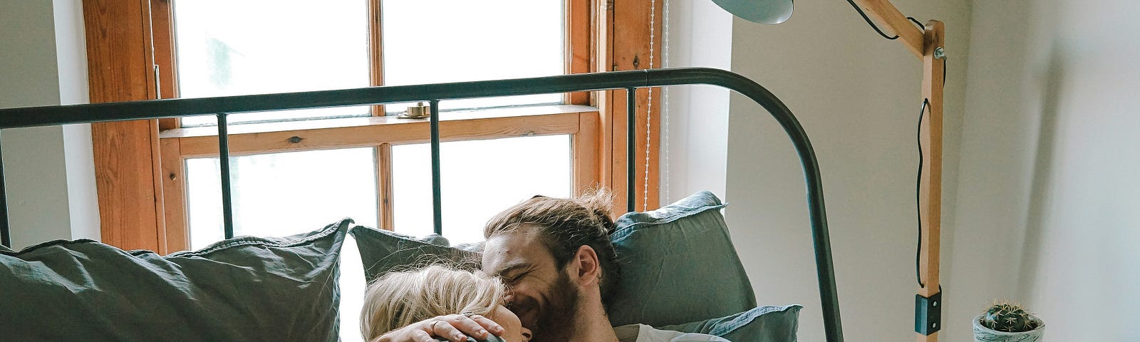 two people under the sheets of the bed