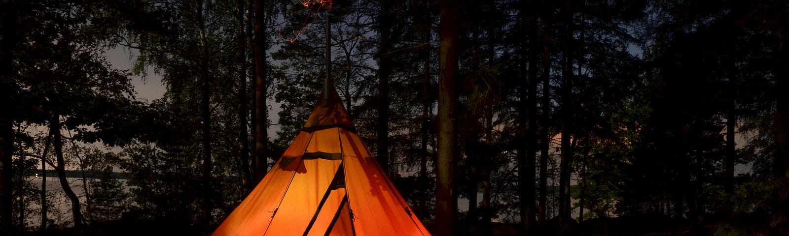 A tipi glows in the darkness