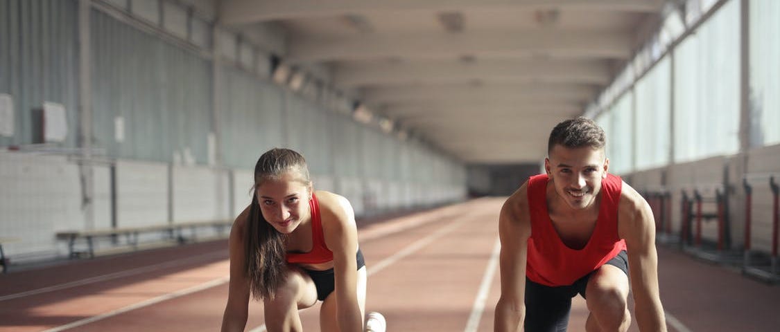 Two teenagers preparing to run and looking prepared to tackle the challenge