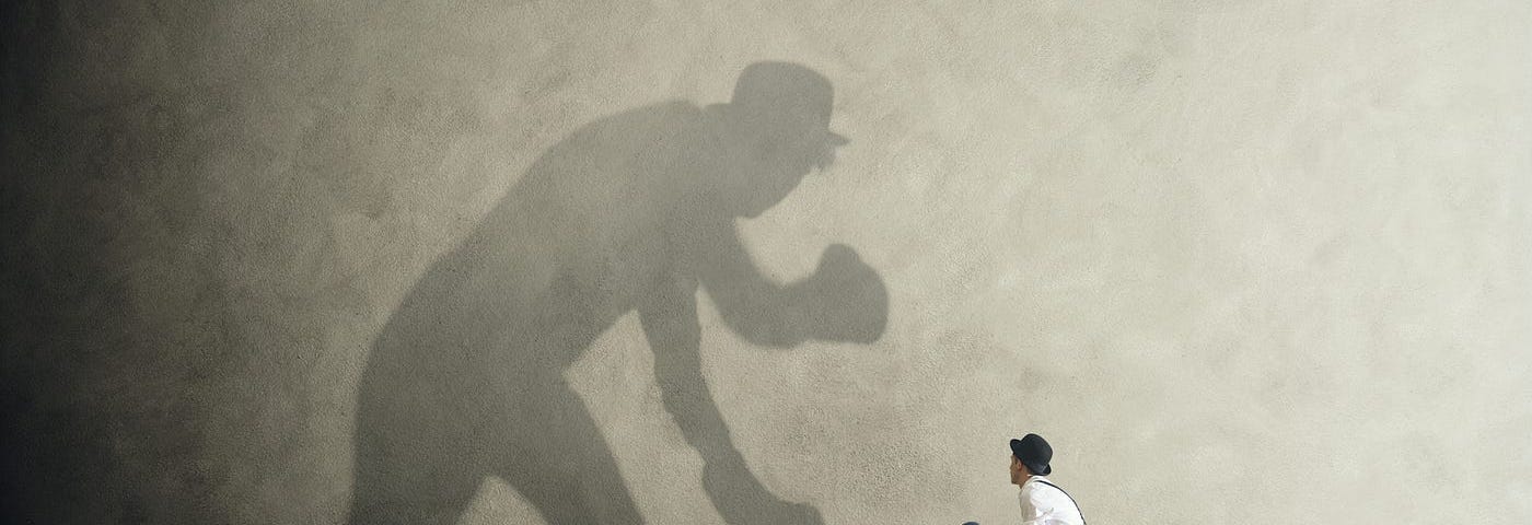 Man boxing with his own shadow.