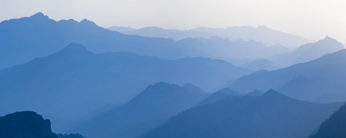 A range of misty blue mountains stretching into the distance.