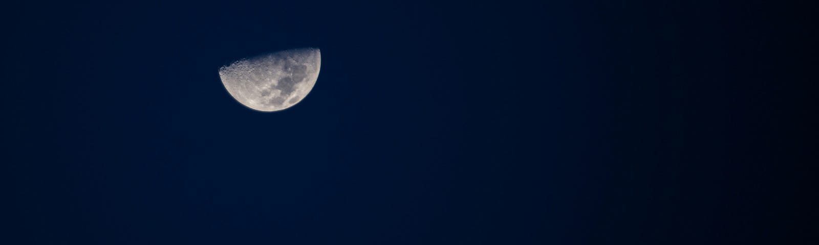 First quarter moon on deep blue sky