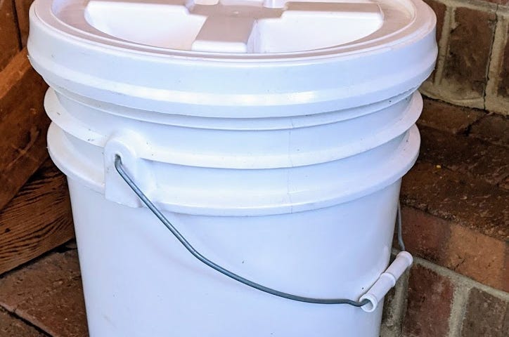 A plastic 5-gallon bucket with a gamma-seal lid