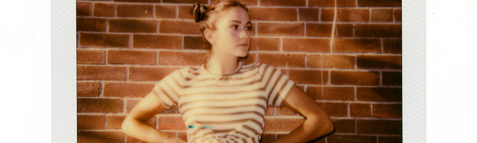 An old-fashioned Polaroid image of a young blonde woman, her hands on her hips. She faces us, looking at a 45 degree angle to her left. There is a brick wall in the background. You can improve your sleep quality and wake up refreshed with a few simple adjustments.