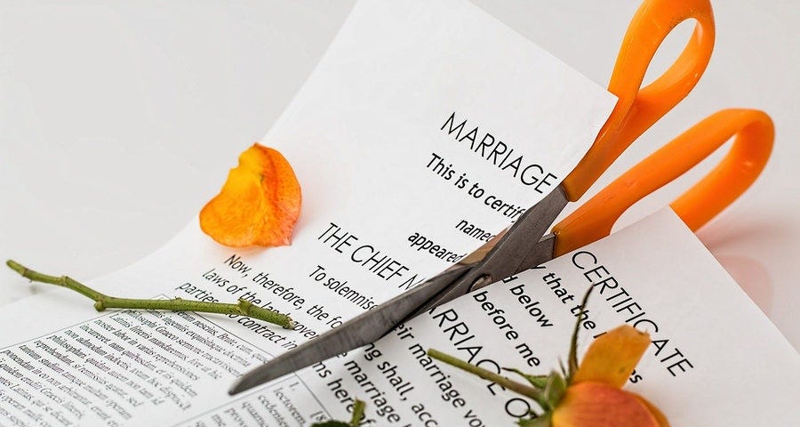 A marriage contract with a rose thereon, both cut with a pair of scissors