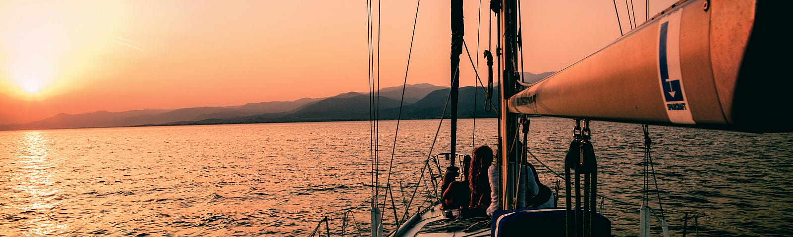 A sailboat navigating on sunset — Photo by Markos Mant on Unsplash