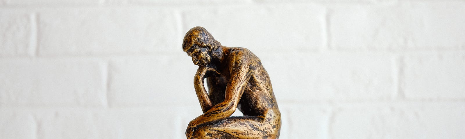 Statue of a man in thinking man pose