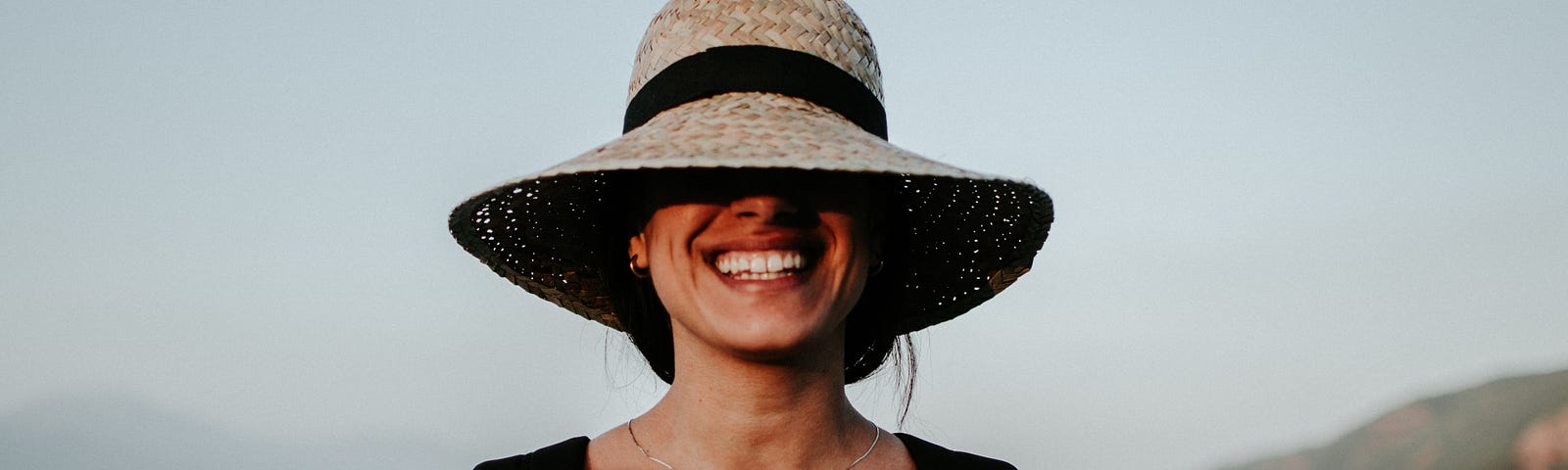 woman smiling on the beach alone