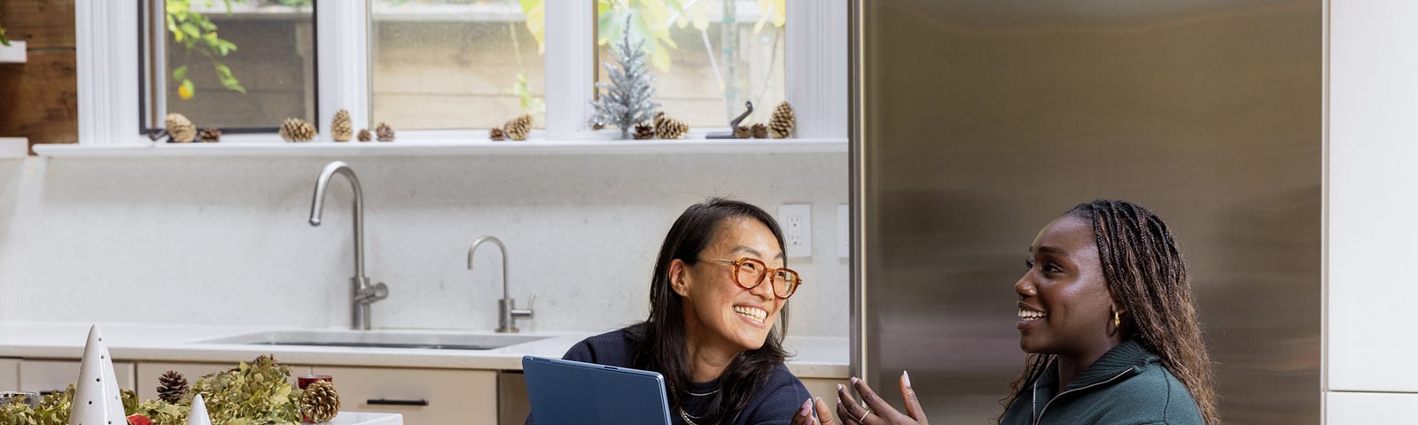 Image of two women talking in a kitchen.